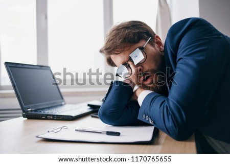 a man stuck daisies on glasses and sleeps in the workplace                         