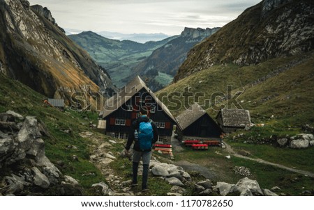 
Hiker is alone on the rock summit. Wonderful daybreak in mountains in deep valley. The mountain of the Alpstein, Switzerland, Autumn 2017