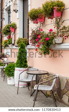 Store front of a flower shop with table and a chears selling garden plants