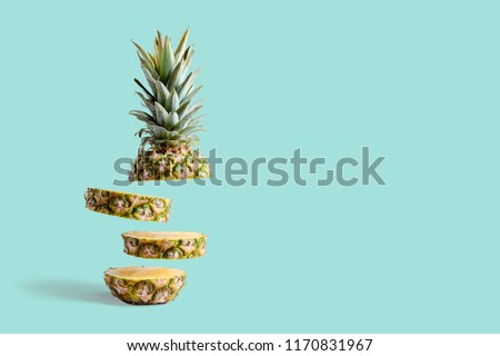 Sliced pineapple on pastel blue background. Minimal fruit concept. Royalty-Free Stock Photo #1170831967