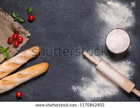 home-made bread and baguette on a gray background with flour