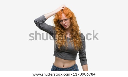 Young redhead woman confuse and wonder about question. Uncertain with doubt, thinking with hand on head. Pensive concept.