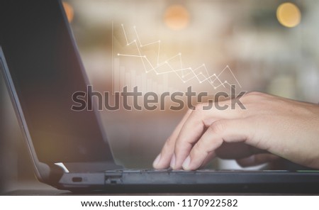 Business man hand working with  new modern computer and business strategy (graph)