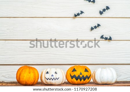 Halloween pumpkins on wooden planks with wooden background.