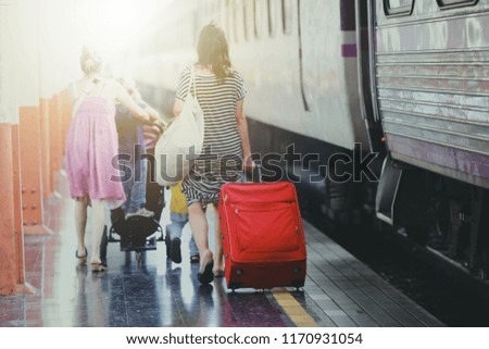 Back side of Multiethnic Travellers are looking the destination at the train station, Travel and transportation concept