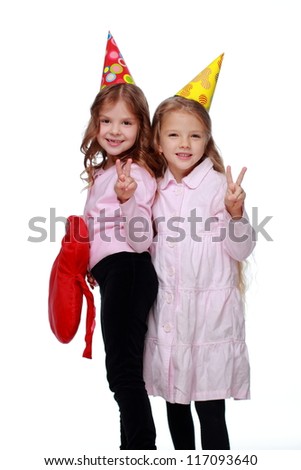 Studio image of laughing kids in party hats