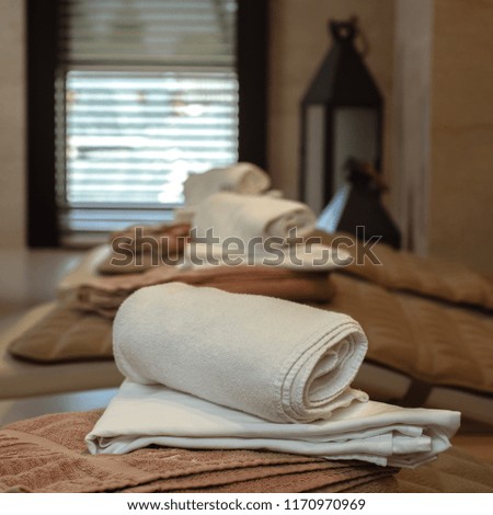 Closeup photo of cotton rolled towels in spa salon