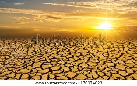 arid Clay soil Sun desert global worming concept cracked scorched earth soil drought desert landscape dramatic sunset Royalty-Free Stock Photo #1170974023