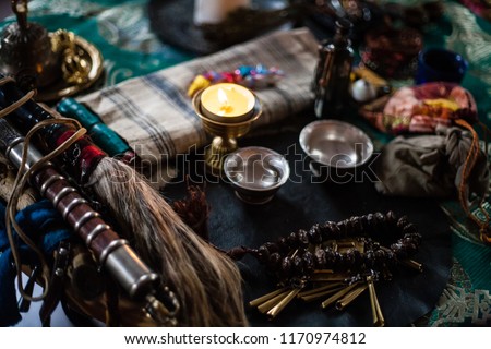 shamanic table. candles and herbs for rituals. close-up of religious accessories. fit for rituals, esoteric. shamanic attributes