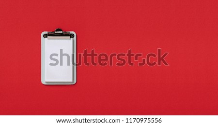 empty Clipboard on red horizontal background. Flat lay, top view trendy for banner 