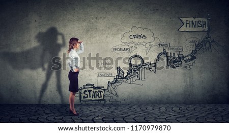 Business career challenges concept. Businesswoman imagining to be a super hero looking aspired making career plans Royalty-Free Stock Photo #1170979870