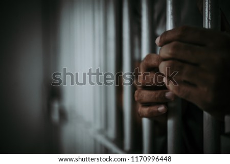 Hands of men desperate to catch the iron prison,prisoner concept,thailand people,Hope to be free. Royalty-Free Stock Photo #1170996448
