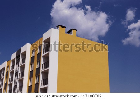 photo with a facade of a new building on the background of the sky. summer city landscape. new building