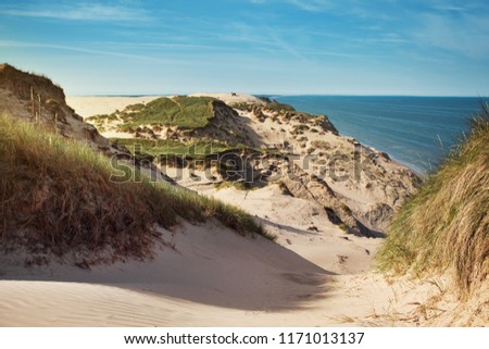 Landscape nature sand dunes with grass and sand texture in summer and bright light. Rubjerg Knude Lighthouse, Lønstrup in North Jutland in Denmark, Skagerrak, North Sea