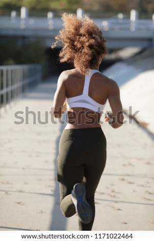 Mixed race female working out in park