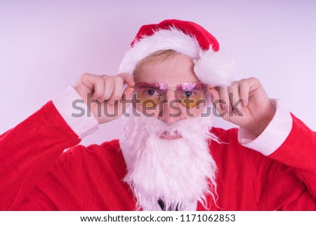 Emotional Santa Claus with glasses on blue background. Happy New Year and merry Christmas!

