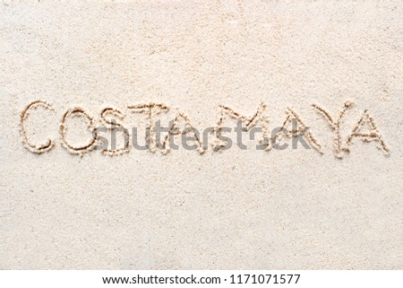 Handwriting words "Costa Maya" on sand of beach