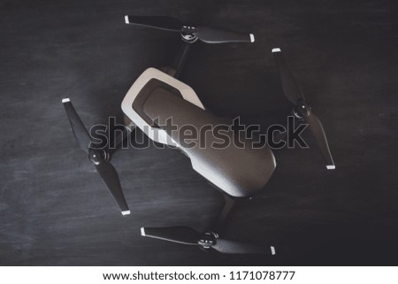 Top View of drone Engines and blades macro Details. Innovation photography concept. A new black drone on a black table. Vertical shot Mate color. The concept of using drones in life and industry.