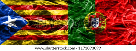 Catalonia vs Portugal copy smoke flags placed side by side. Thick colored silky smoke flags of Catalan and Portugal copy
