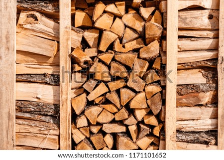 Firewood is sold in a German shop. Packages with firewood for fireplace or stove heating