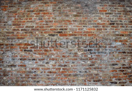Grunge cracked old brick wall, front view, feeling vintage. Concept background of brickwork.