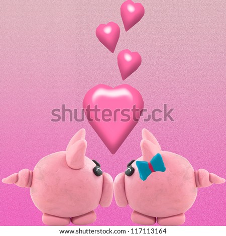 Pig made from clay in kissing. It is meaning love by kissing.