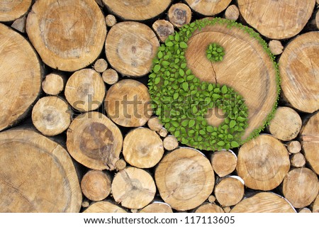 Stacked Logs Background with ying yang symbol Royalty-Free Stock Photo #117113605