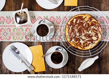 Chocolate cheesecake and coffee on wooden background. Cup coffee and cheesecake.Top view. Flat lay