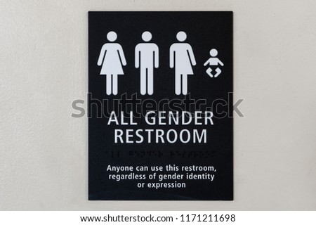 All gender restroom sign on a white wall. Black sign with white letters and illustrations