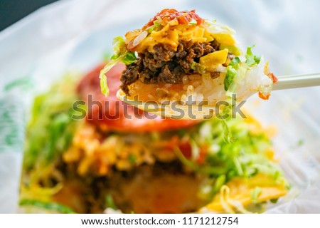 taco filling and rice in Okinawa Prefecture, Japan. Taco rice is a dish of Okinawa Prefecture with ingredients of tacos of Mexican-style American cuisine on rice. Royalty-Free Stock Photo #1171212754