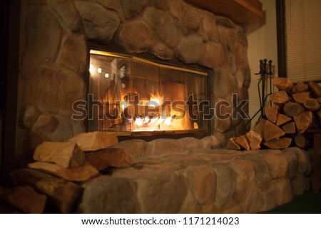 Roaring fire in an arched stone fireplace 