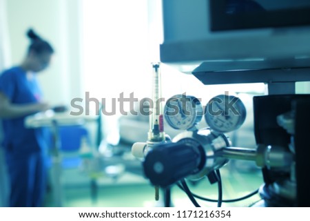 Blurred silhouette of a female medical worker on the background of gas equipment, unfocused background. Royalty-Free Stock Photo #1171216354