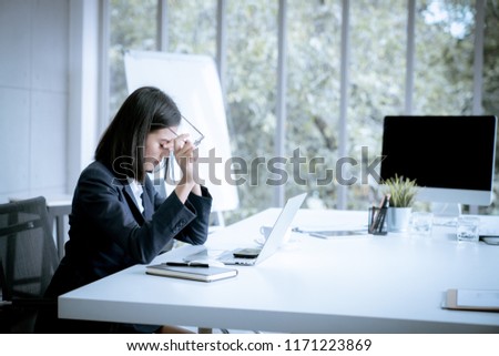 Asian business woman headache stressed because of work mistake problems about profit losses to be risk for fired from her job Royalty-Free Stock Photo #1171223869