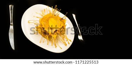 Autumn picture, Comic theme, plate, autumn leaves, fork and knife. Breakfast hedgehog. Photo taken against a black background