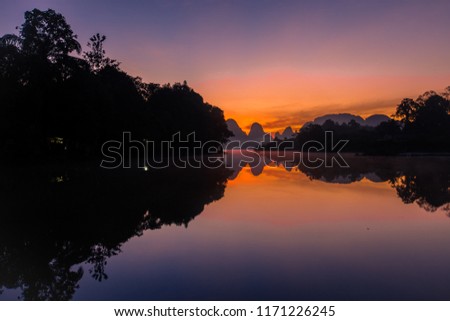 Nong Thale Mueang Krabi District is a reservoir surrounded by valleys, mountains and colorful sunrise in the morning. And there is a fog of water floating over the surface of the water.It is beautiful
