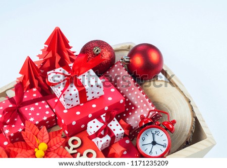 Christmas gift box and decorations in a wooden box.Flat lay template. The time of the Christmas miracle. Red decorative ornament on a white background.
