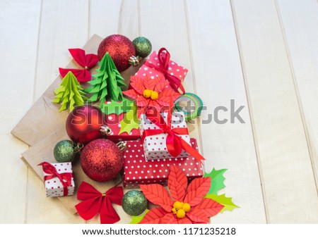 Christmas gift boxes and decorations. Flat lay template. The time of the Christmas miracle. Red decorative ornament on a wooden background.