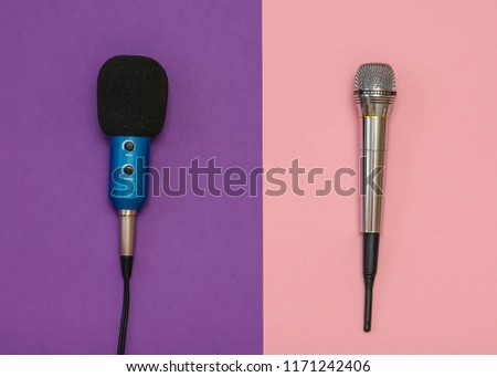 Wireless microphone, classic microphone with wire on a pink and purple background. Flat lay.