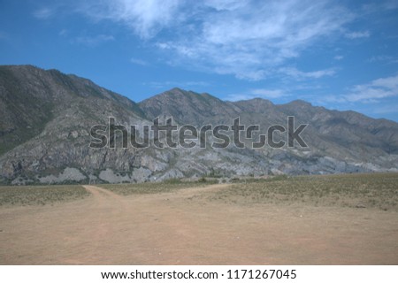 
High-mountain valley in the basin of the mountain ranges under the blue sky. The Republic of Gorny Altai. The picture was taken on a warm summer day.
