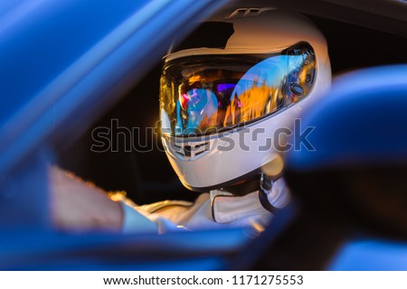 A Helmeted Race Car Driver At The Wheel Royalty-Free Stock Photo #1171275553