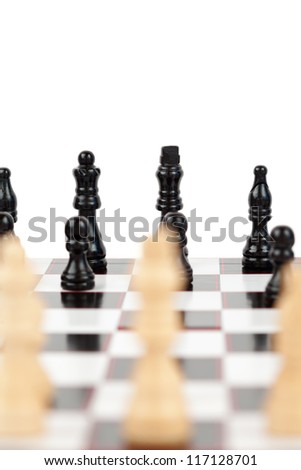 White and black chess pieces facing each other on the board