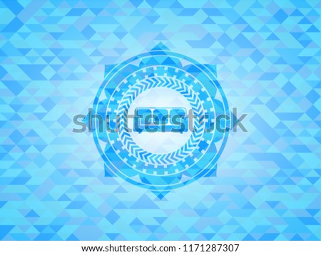 couch icon inside light blue mosaic emblem