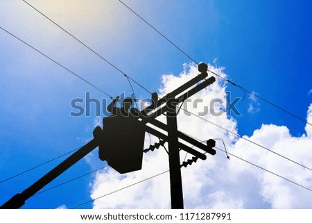 Silhouette engineer or electrician is working on a bucket. To repair high-voltage transmission lines.