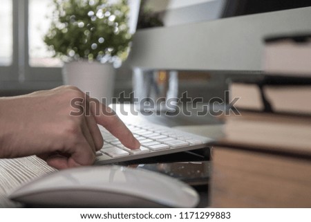 Finger of woman press enter key on keyboard computer in the office.
