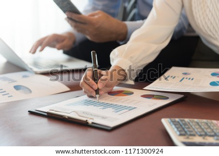 Business women reviewing data in financial statement with coworker analyzing market data research for new business startup. Royalty-Free Stock Photo #1171300924