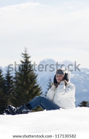 Young woman sitting on the snow
