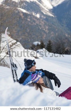 Young couple relaxing on the snow