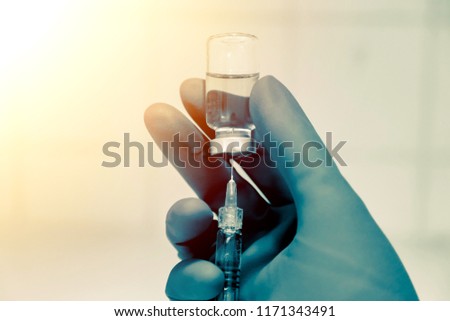 Medical hand glove blue molding vial vaccine hypodermic needle syringe injection treatment.Lab since test immunization and vaccination concept.drug insulin care prevention  diabetes disease hospital. Royalty-Free Stock Photo #1171343491