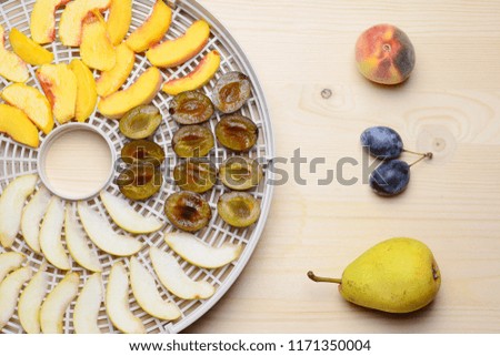 Fresh slices fruit prepared for drying at home. Wooden background.