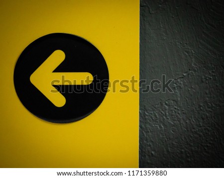 Yellow traffic sign "Turn left" in the parking